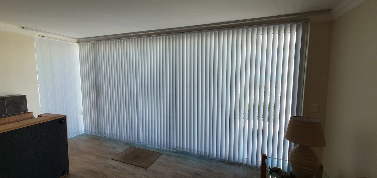 Vertical blinds covering a large sliding door in a lounge