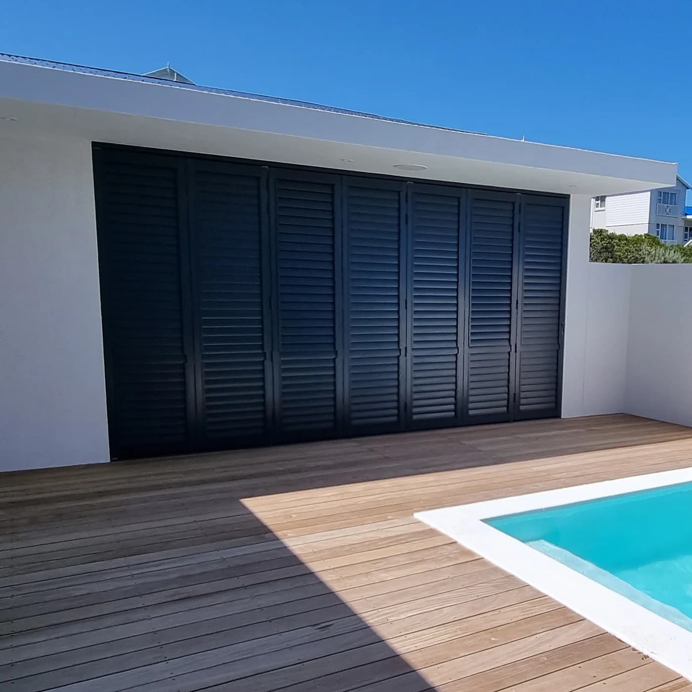 Aluminium security shutters beside a pool deck in Blouberg