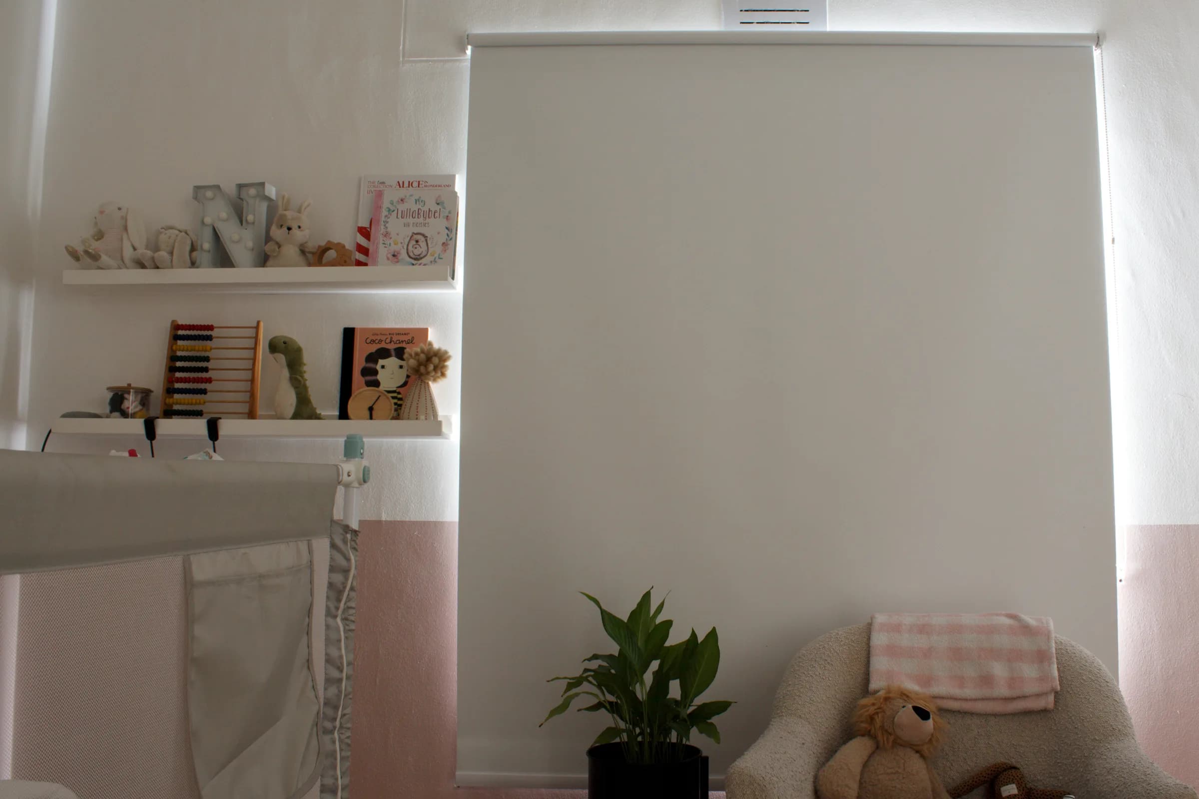Opaque blockout roller blind fully extended over a nursery window