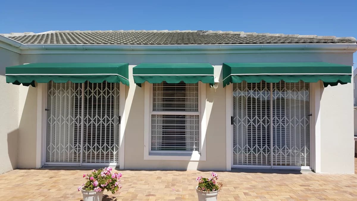 Fixed box wedge awnings over windows with security shutters