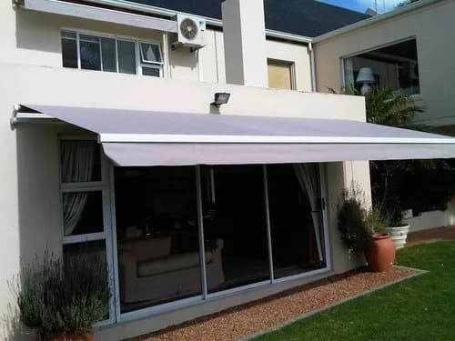 Fold arm awning extended over a patio sliding door