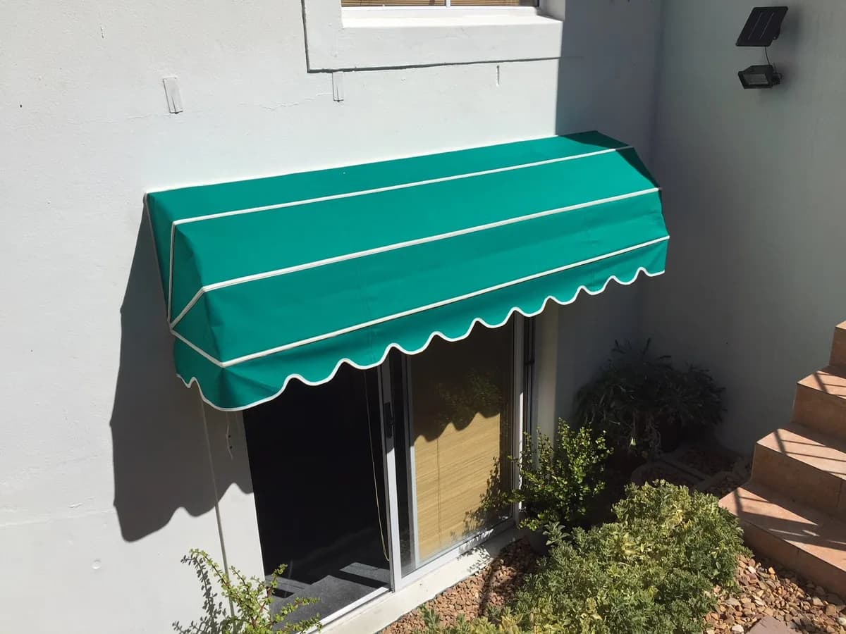 Green pramhood awning over a sliding door