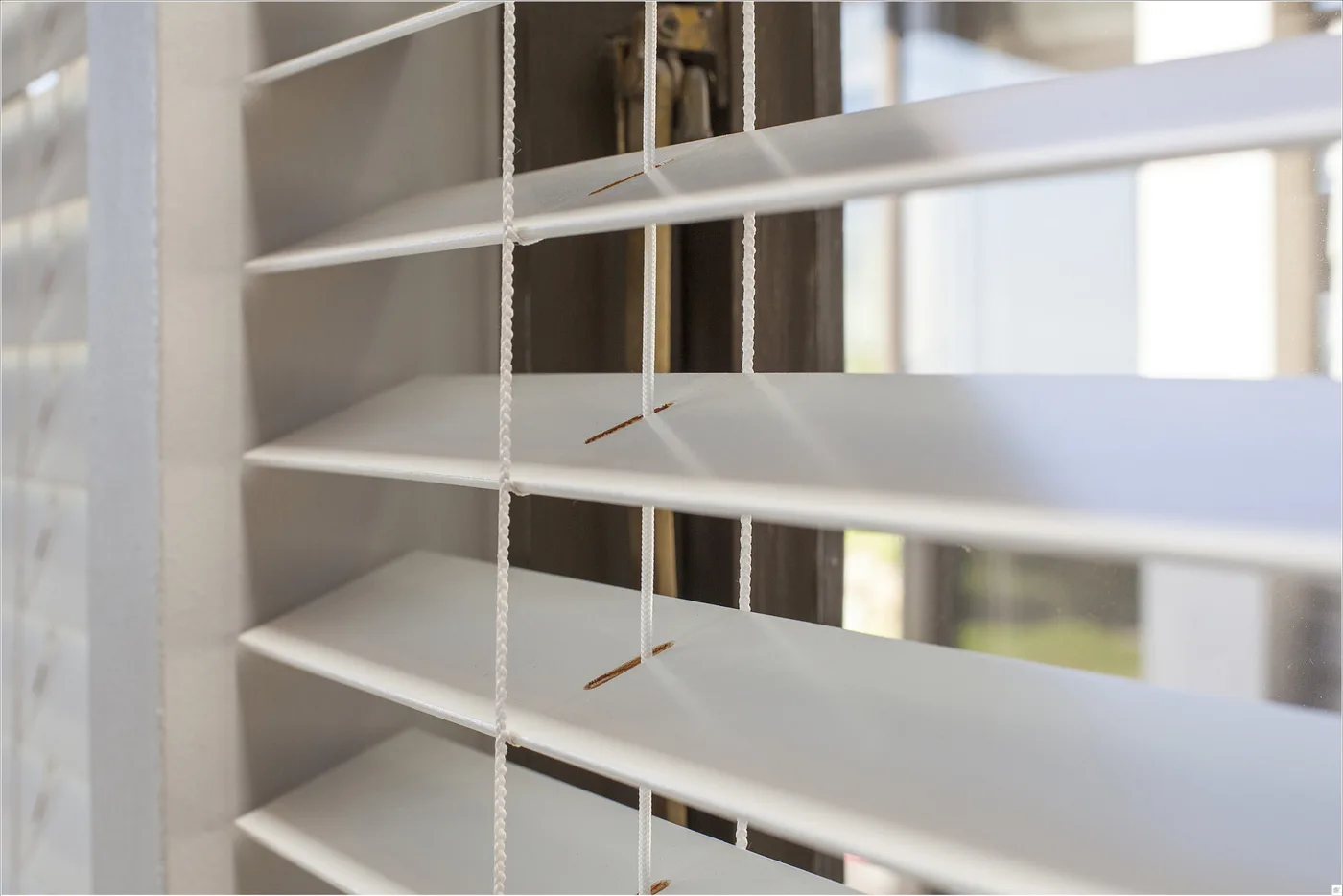 Close-up of a painted basswood venetian blind and lift cords